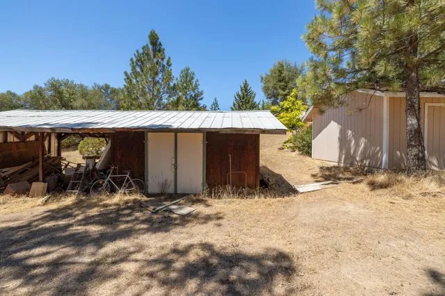 a backyard of a house with table and chairs