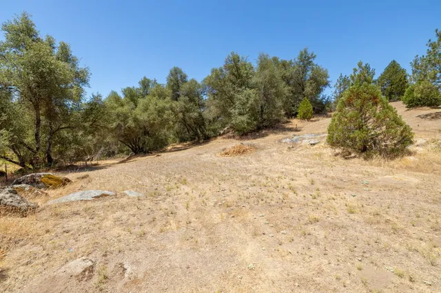 a view of a house with a yard and garage