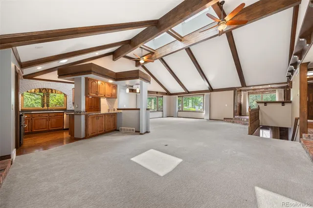 a kitchen with stainless steel appliances granite countertop a stove a sink and a refrigerator