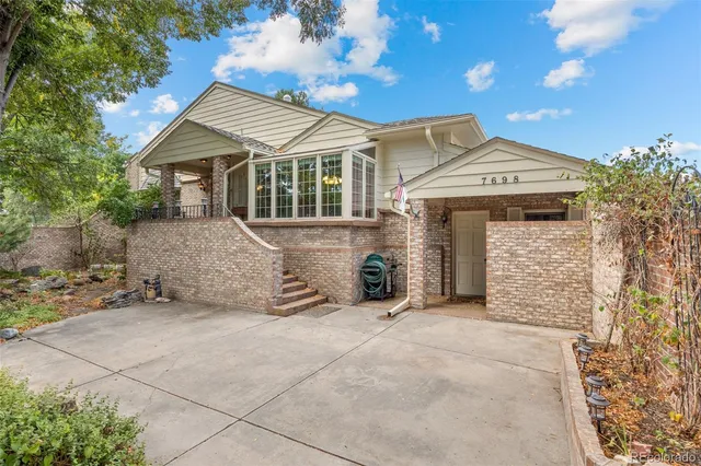 a view of a chair and table in backyard of the house