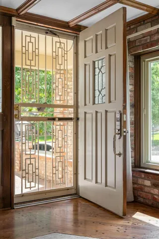 a view of front door and porch with wooden floor