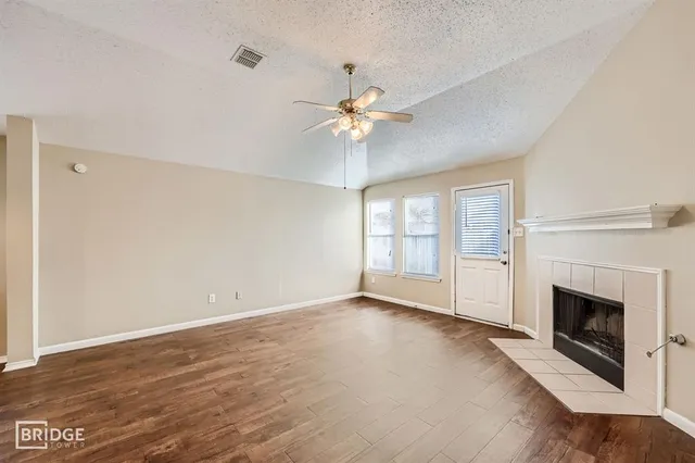 a view of empty room with fireplace and fan