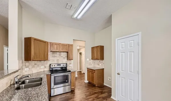a kitchen with a refrigerator stove and sink