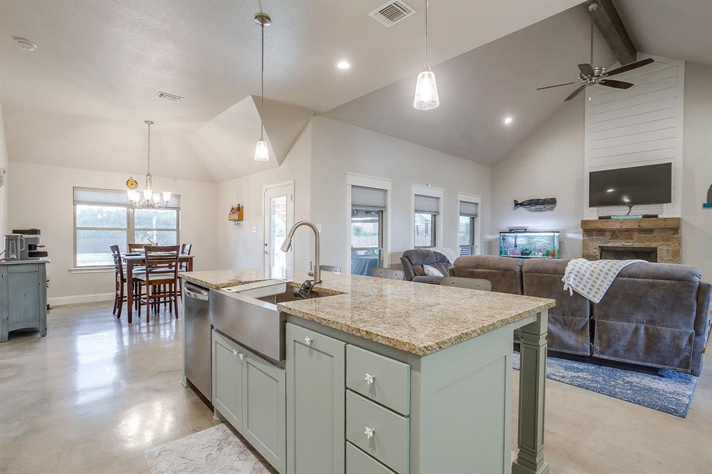 111 Treys Way Godley, TX 76044 - Photo 18 of 38 a kitchen with center island table and chairs