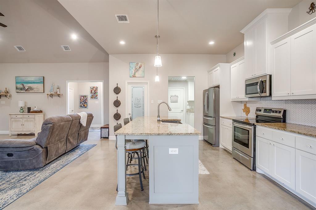 111 Treys Way Godley, TX 76044 - Photo 19 of 38 a large white kitchen with stainless steel appliances granite countertop lots of counter top space