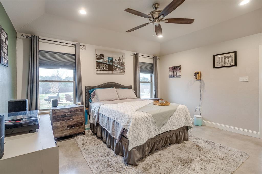 111 Treys Way Godley, TX 76044 - Photo 20 of 38 a bedroom with a bed a ceiling fan and a large window