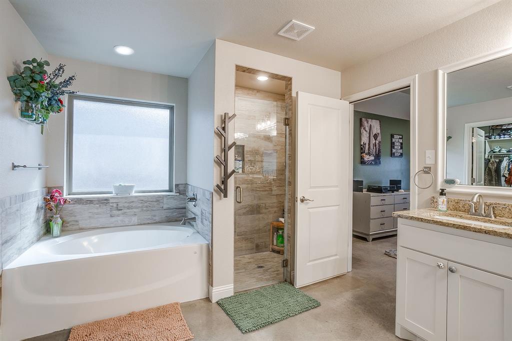 111 Treys Way Godley, TX 76044 - Photo 25 of 38 a bathroom with a tub sink and mirror