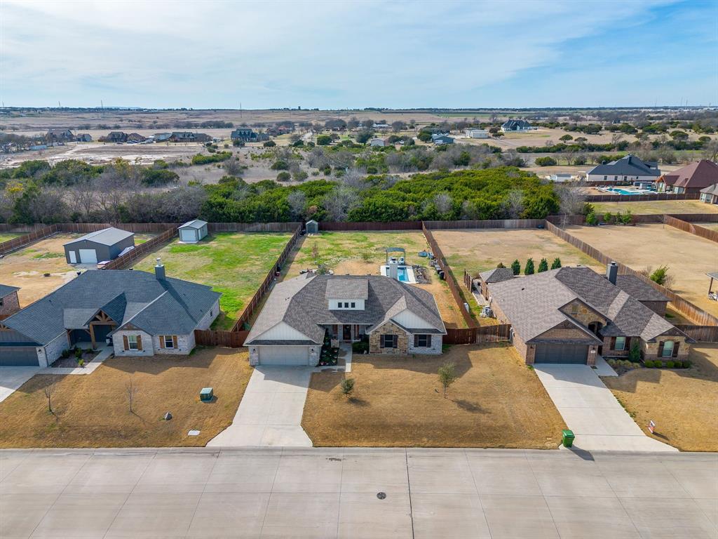 111 Treys Way Godley, TX 76044 - Photo 4 of 38 an aerial view of a house with a swimming pool and lake view