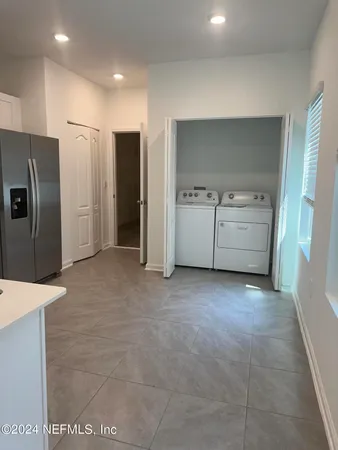 a kitchen with refrigerator and cabinets