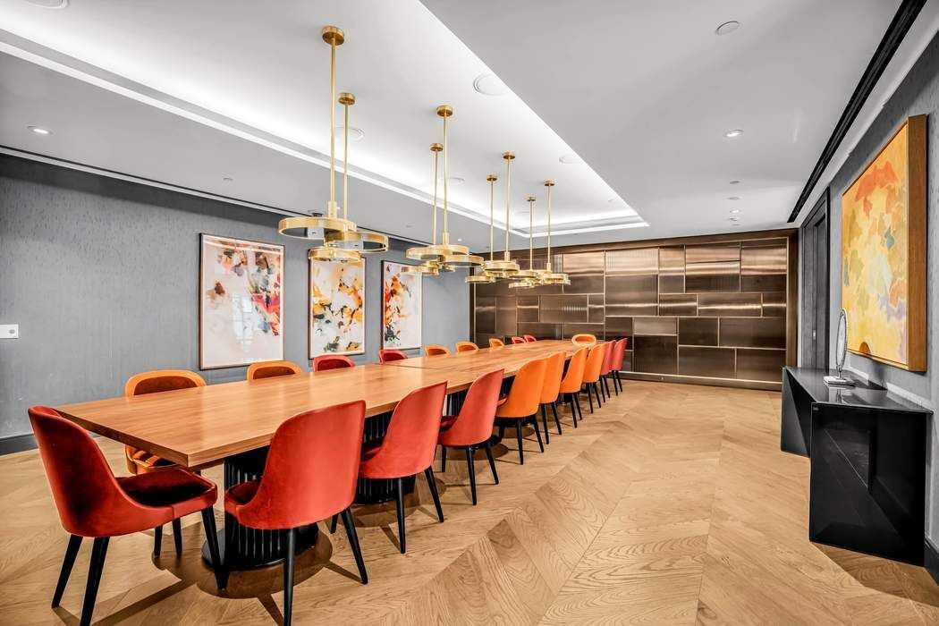 515 West 18th Street, Unit 308 Manhattan, NY 10011 - Photo 11 of 16 a dining room with stainless steel appliances kitchen island granite countertop a table and chairs