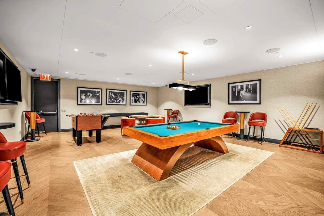 515 West 18th Street, Unit 308 Manhattan, NY 10011 - Photo 13 of 16 a living room with furniture and a flat screen tv