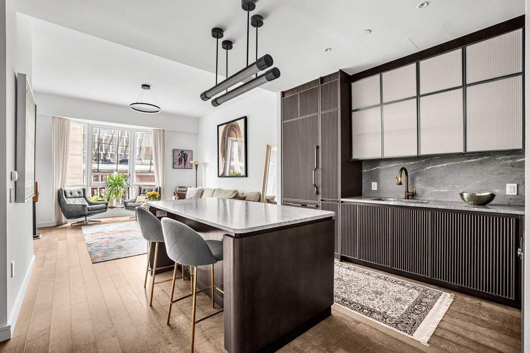 515 West 18th Street, Unit 308 Manhattan, NY 10011 - Photo 2 of 16 a kitchen with sink cabinets and wooden floor