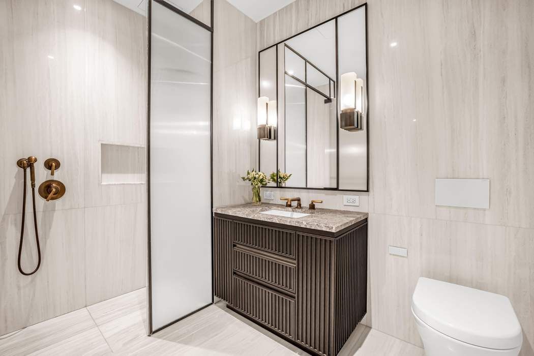515 West 18th Street, Unit 308 Manhattan, NY 10011 - Photo 6 of 16 a bathroom with a granite countertop sink toilet and shower