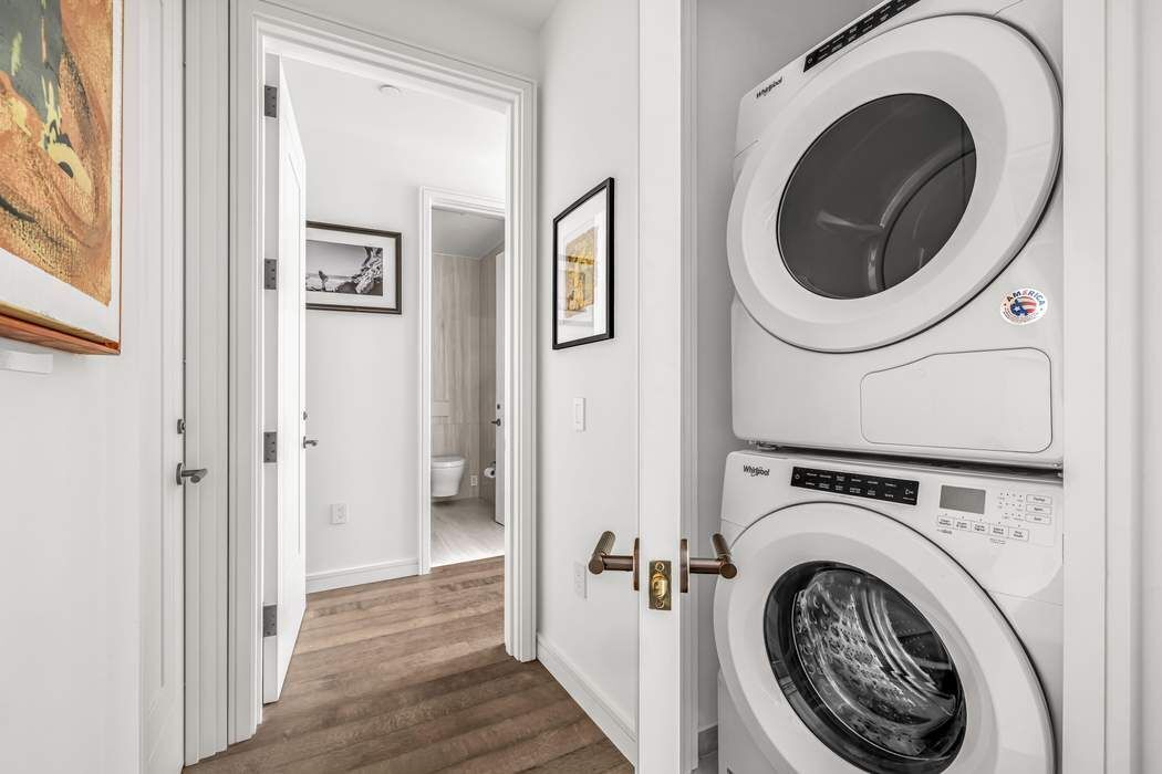 515 West 18th Street, Unit 308 Manhattan, NY 10011 - Photo 7 of 16 a view of a hallway with washer and dryer