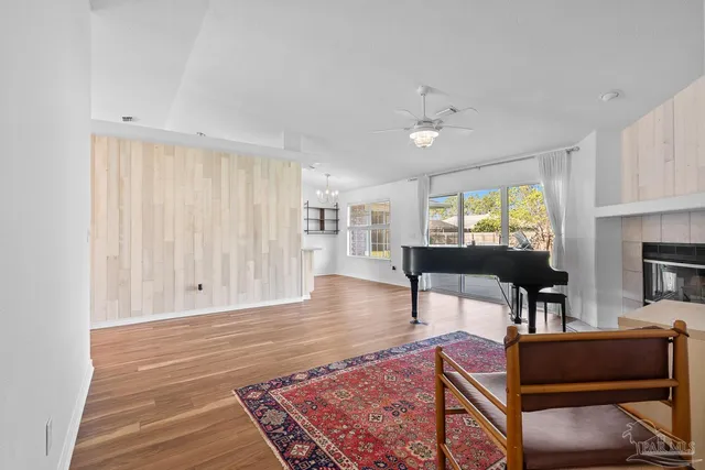 a living room with furniture a window and a flat screen tv