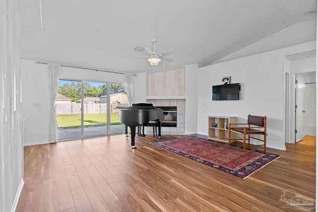 a view of a living room with hardwood floor and a flat screen tv