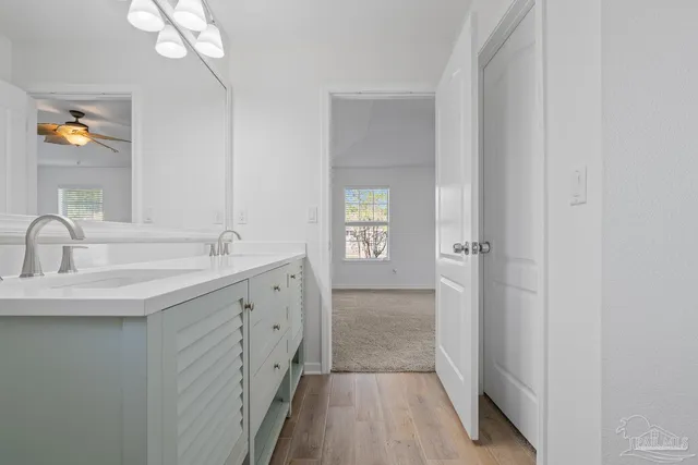 an empty room with windows and fan