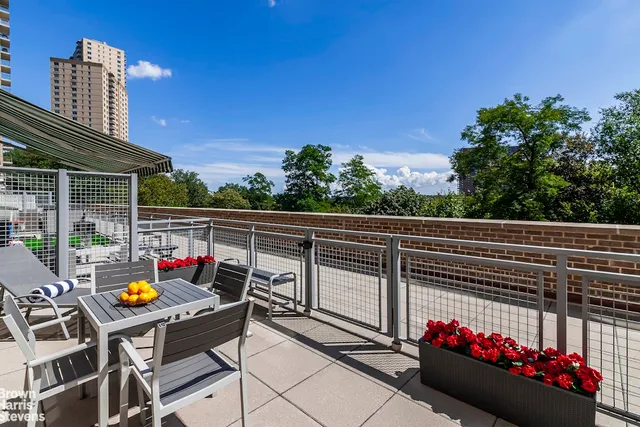 a view of a patio with table and chairs and potted plants