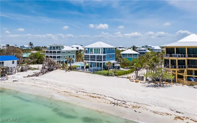 a view of a house with a yard and sitting area