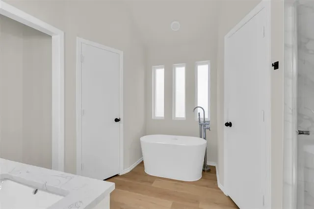 an empty room with a hardwood and wooden floor