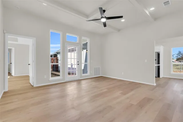 a kitchen with granite countertop white cabinets and stainless steel appliances