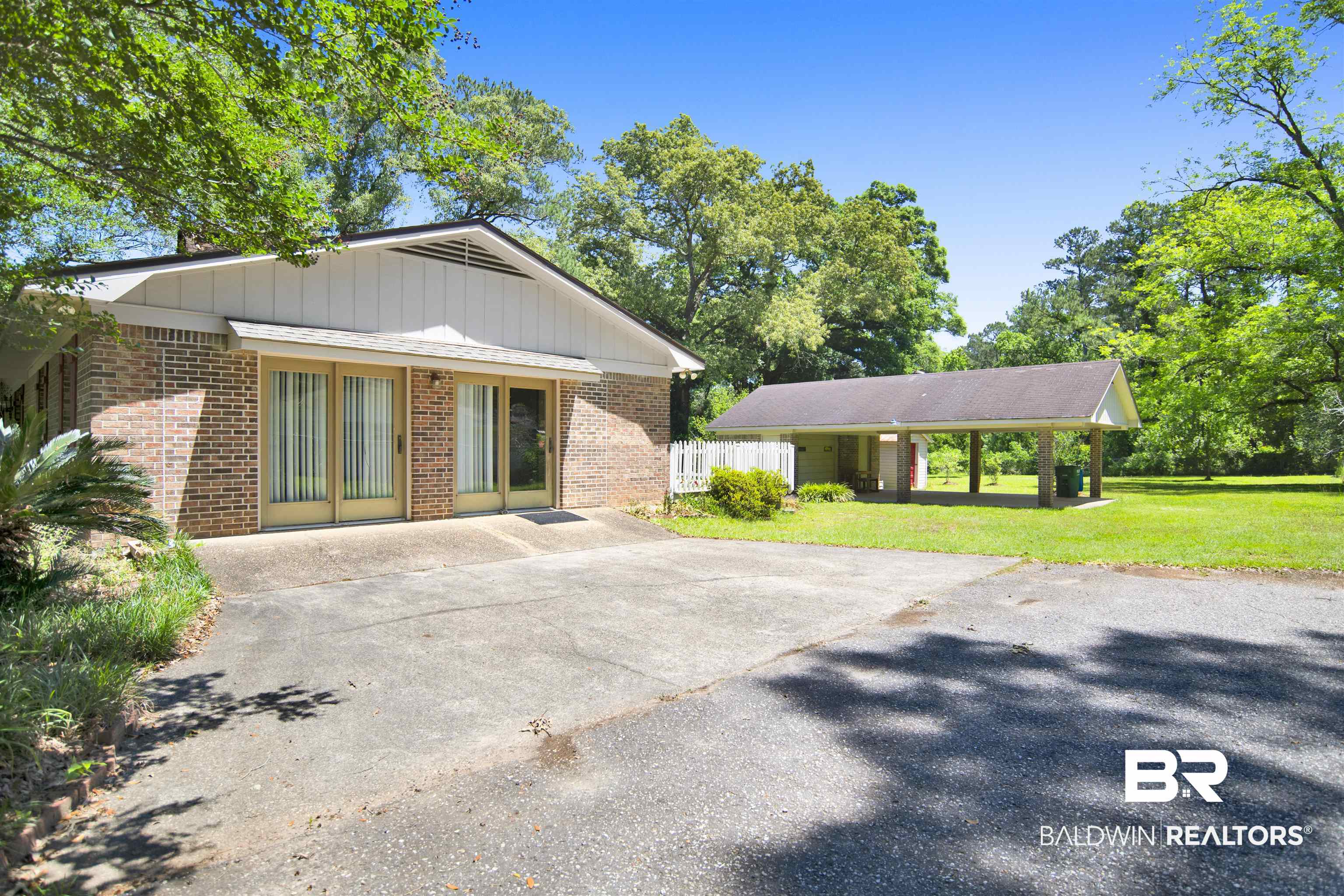 30888 Cemetery Road Daphne, AL 36527 - Photo 32 of 36 Brick exterior with a gabled roofline and a front entry featuring sliding glass doors