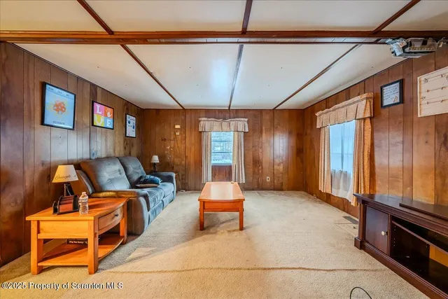 a living room with furniture stove window and flat screen tv