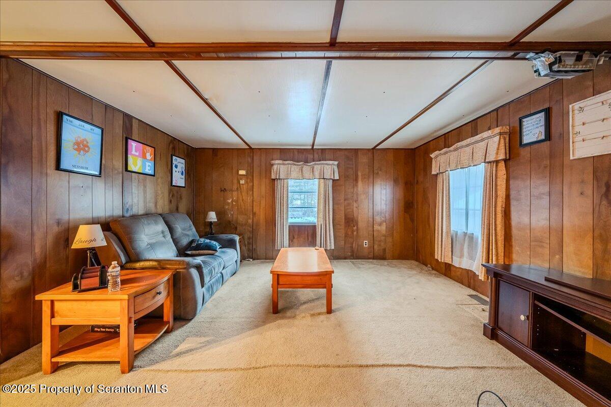 2099 Turnpike Road Dalton, PA 18414 - Photo 3 of 16 a living room with furniture stove window and flat screen tv