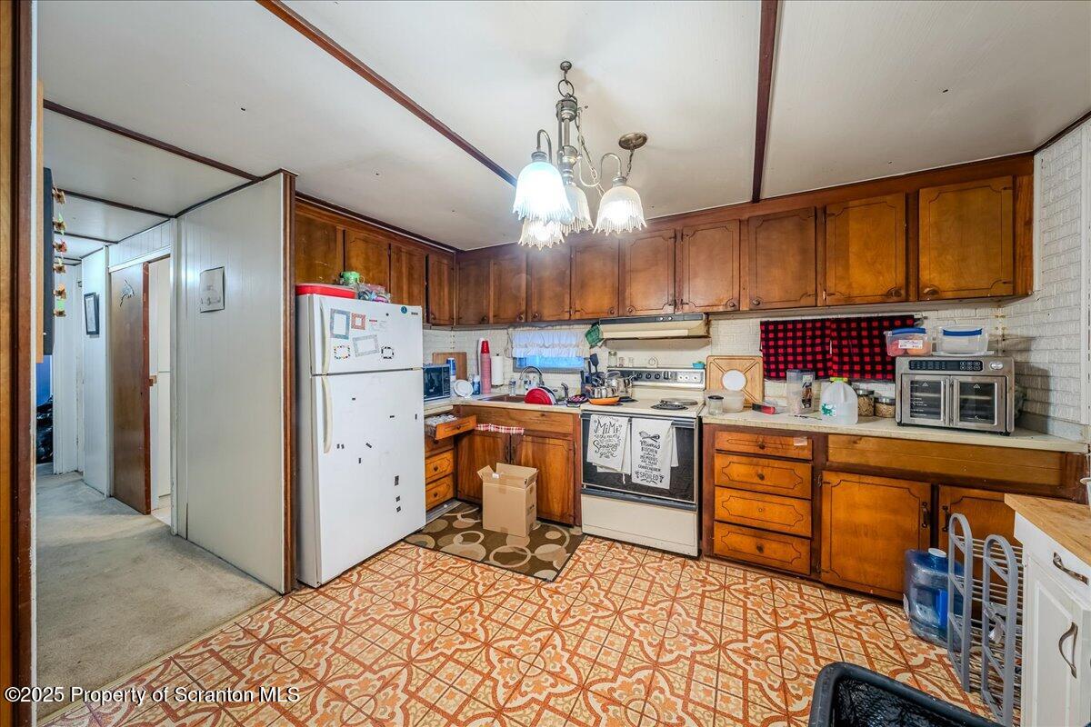 2099 Turnpike Road Dalton, PA 18414 - Photo 7 of 16 a kitchen with refrigerator cabinets and a wooden floor