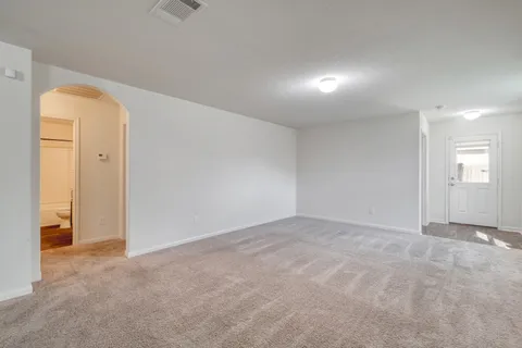 a view of an empty room and a window