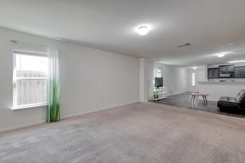 a view of a livingroom with furniture and a window
