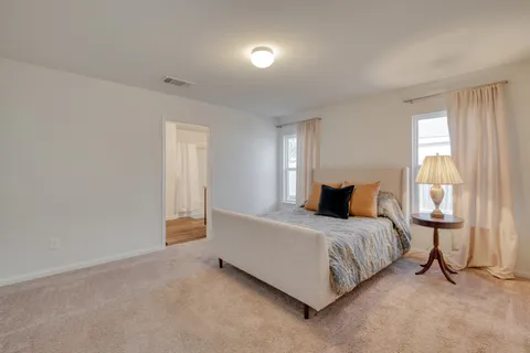 a bedroom with a bed and a lamp
