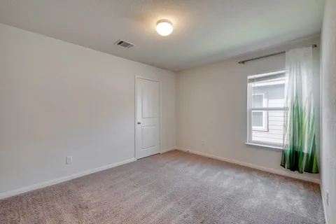 an empty room with a empty space and windows