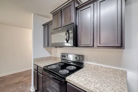 a kitchen with a stove and a microwave