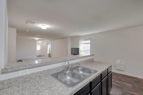 a bathroom with a granite countertop sink a large mirror and vanity