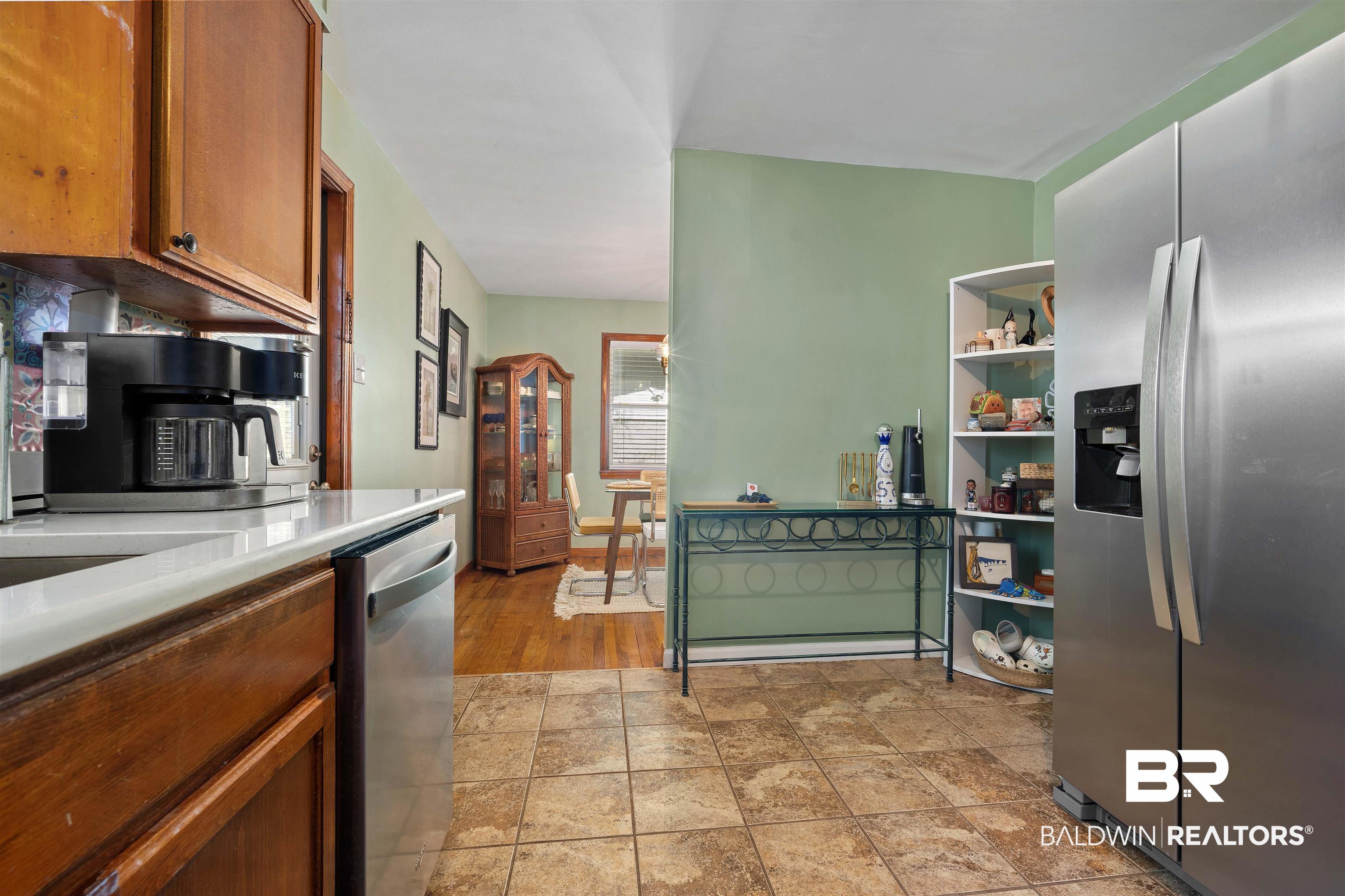 672 Tarawa Drive Mobile, AL 36609 - Photo 12 of 26 Kitchen with stainless steel appliances, wood finish cabinetry, and light countertops