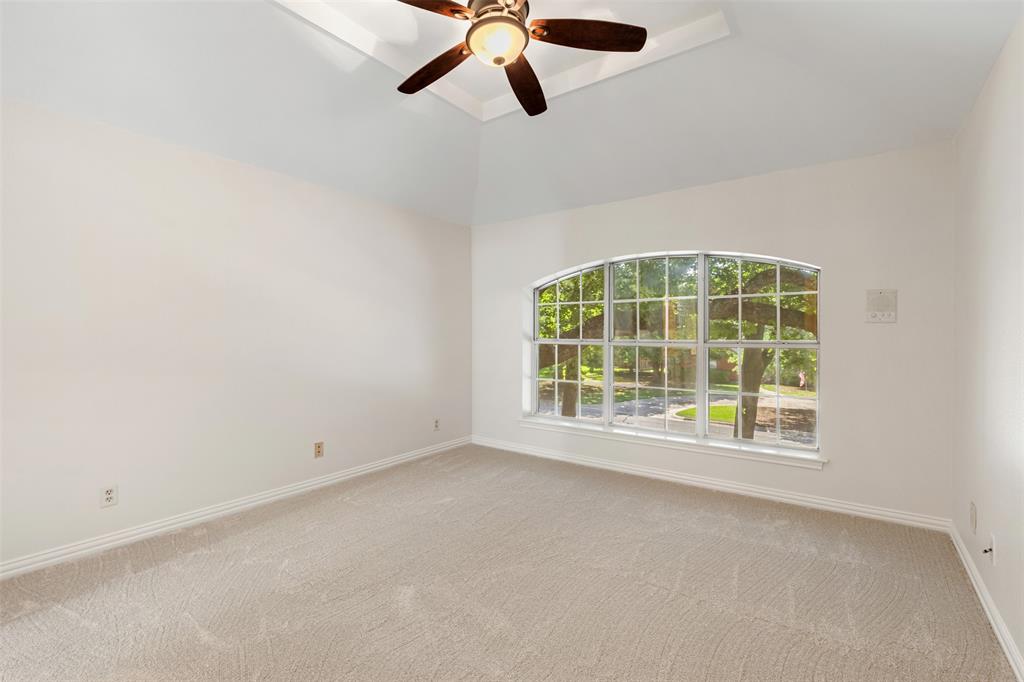 609 Seville Road Denton, TX 76205 - Photo 31 of 40 Upstairs bedroom (front) with carpet & ceiling fan.