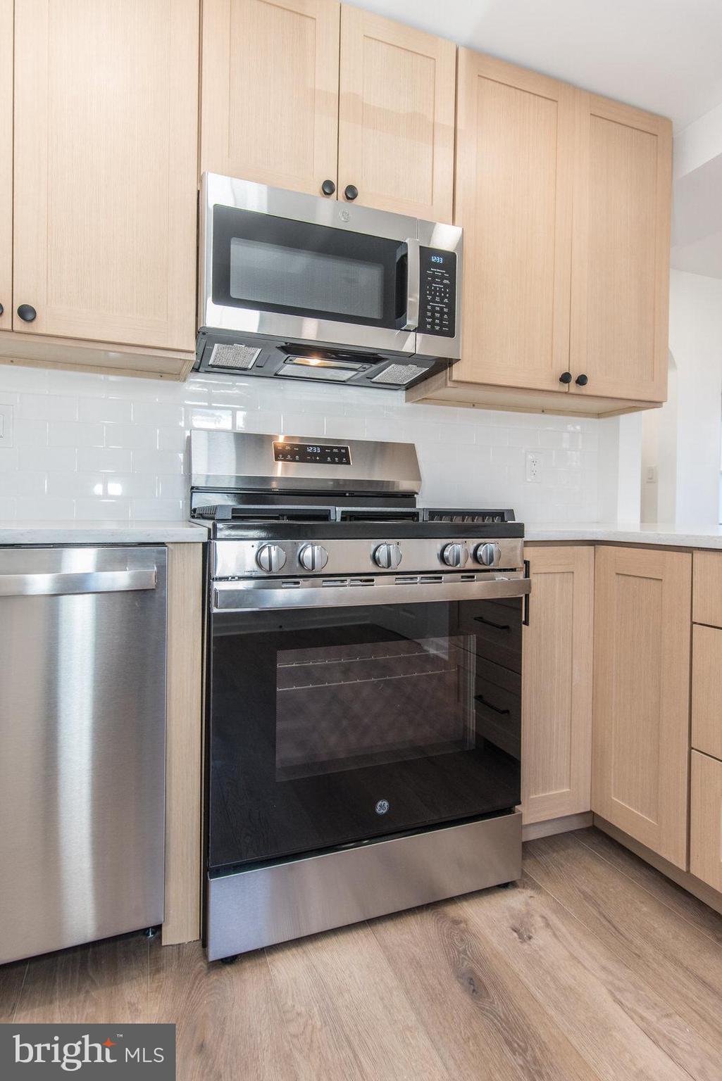 17 Rhode Island Avenue Cherry Hill, NJ 08002 - Photo 26 of 86 a kitchen with stainless steel appliances wooden cabinets and a stove top oven