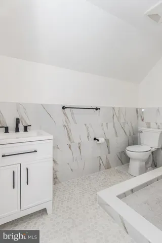 a view of a house with a yard and pathway