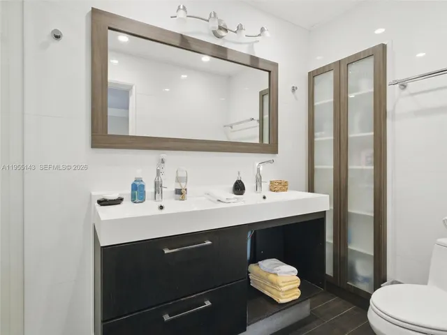 a bathroom with a sink vanity and a mirror