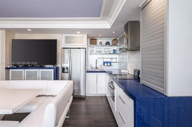 a kitchen with stainless steel appliances a stove a sink and a refrigerator