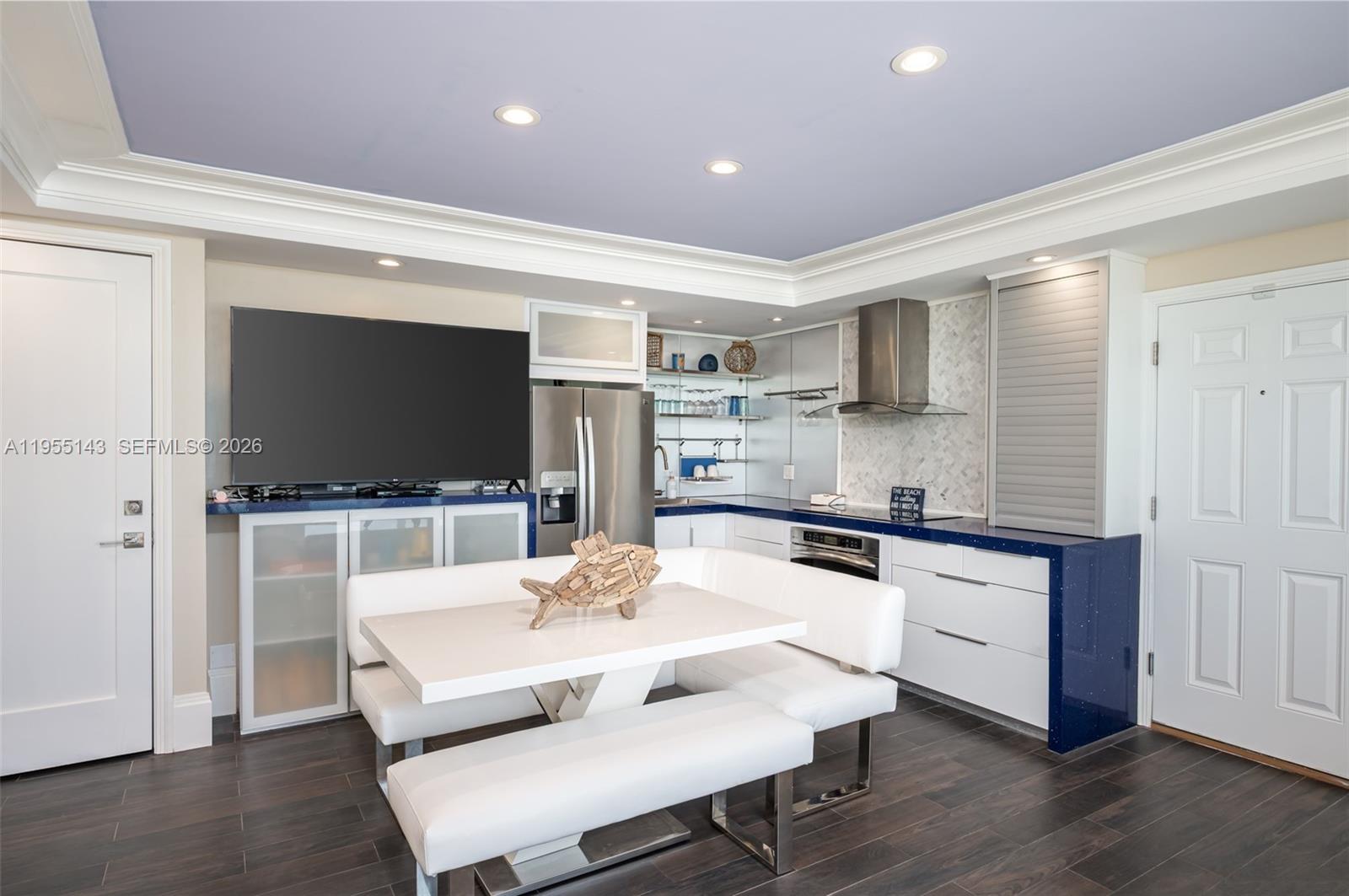 3300 North Surf Road, Unit 17A Hollywood, FL 33019 - Photo 8 of 24 a kitchen with stainless steel appliances a stove a sink and a living room