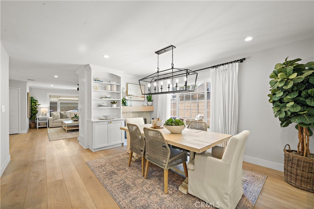 8741 La Roca Avenue Fountain Valley, CA 92708 - Photo 12 of 50 Dining room with fireplace and custom built-ins flows seamlessly into the formal living room