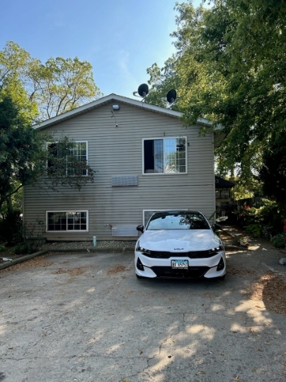 1003 Grand Avenue, Unit 2 Waukegan, IL 60085 - Photo 1 of 1 a car parked in front of house