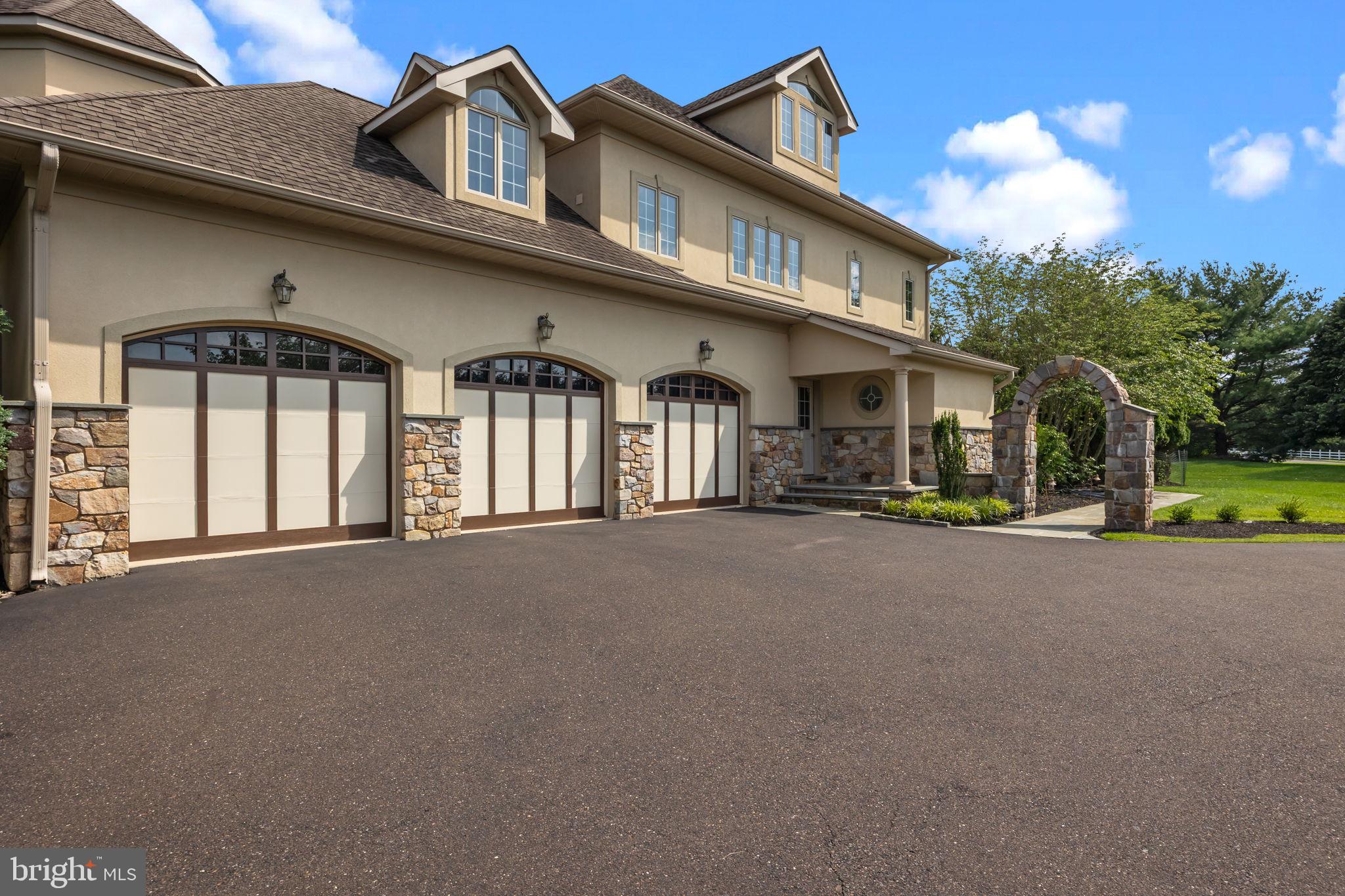 2 Aldans Way Newtown, PA 18940 - Photo 6 of 100 a front view of a house with a yard and garage
