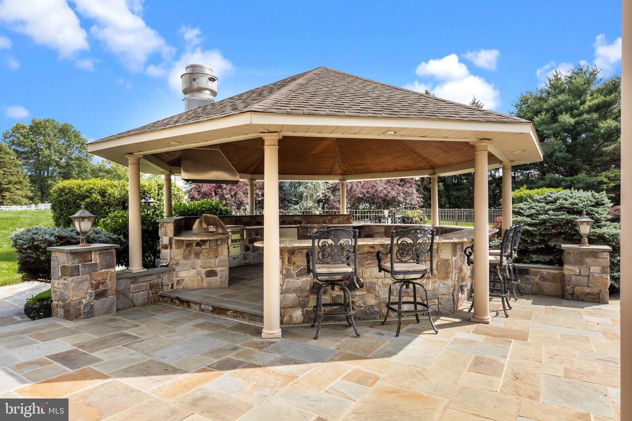 2 Aldans Way Newtown, PA 18940 - Photo 74 of 100 a patio with a table and chairs under an umbrella