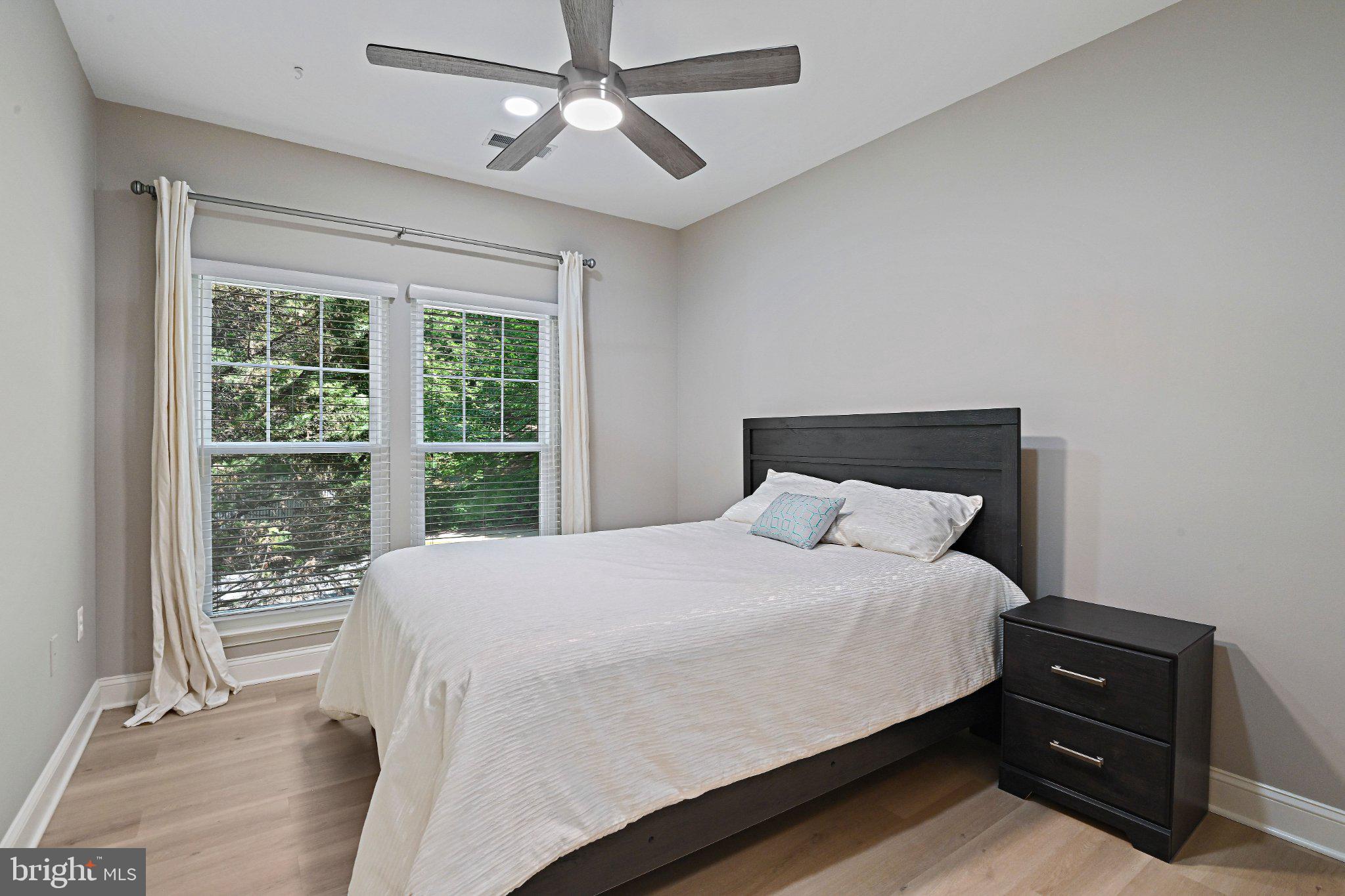 1519 North Point Drive, Unit 202 Reston, VA 20194 - Photo 24 of 49 Serene bedroom with natural light.