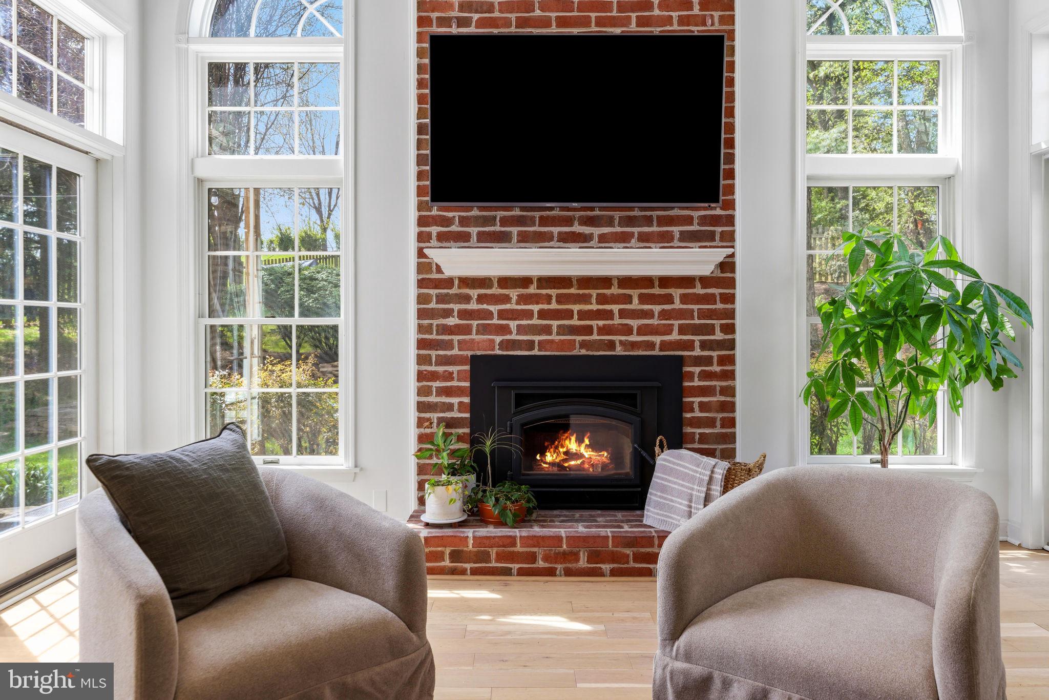 6513 Apple Blossom Ride Columbia, MD 21044 - Photo 17 of 115 a living room with a fireplace a flat screen tv and a window