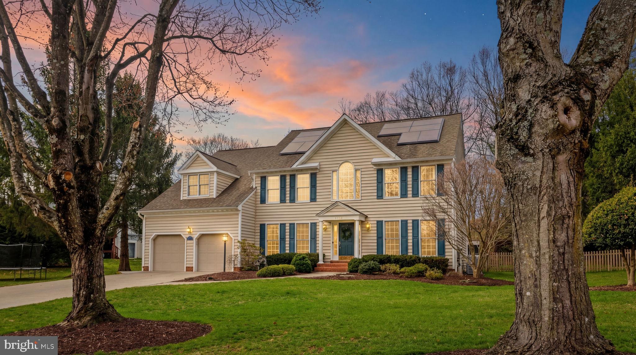 6513 Apple Blossom Ride Columbia, MD 21044 - Photo 2 of 115 a front view of a house with a garden and trees