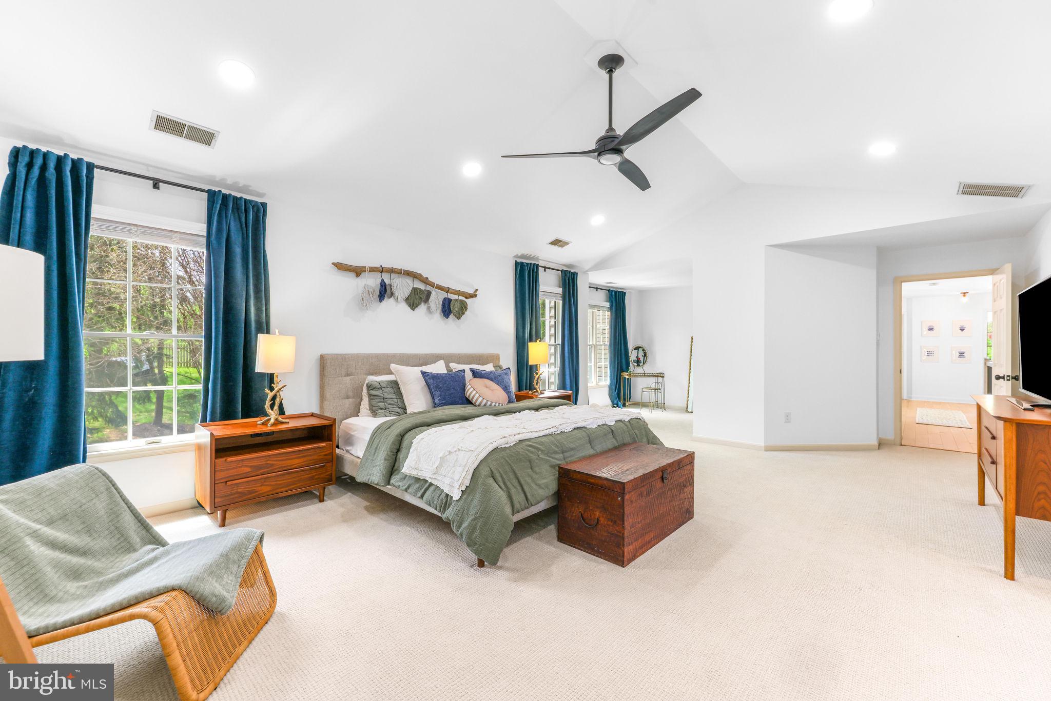 6513 Apple Blossom Ride Columbia, MD 21044 - Photo 41 of 115 a spacious bedroom with a bed a couch and a large window